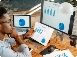 side view man doing analytics while holding an analytic paper